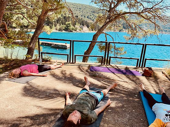Yoga in the shade by the sea